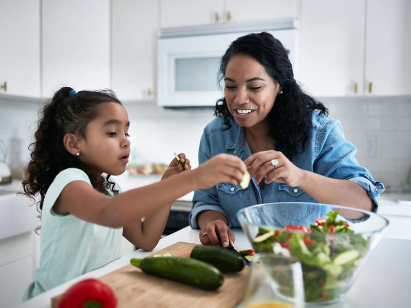 Mom and daughter making a salad