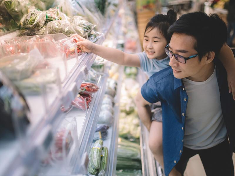 Dad and girl shopping at grocery store