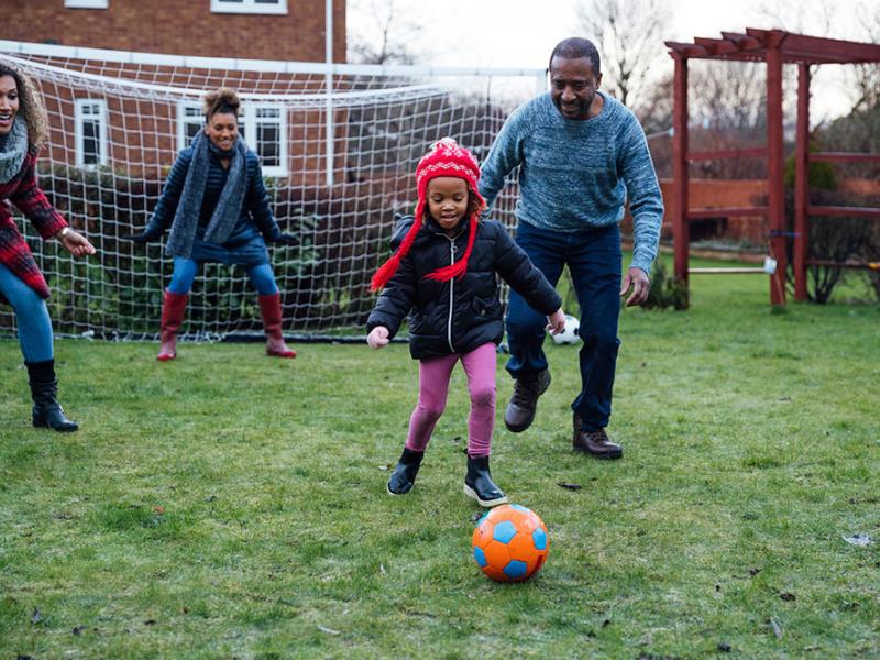 family playing soccer