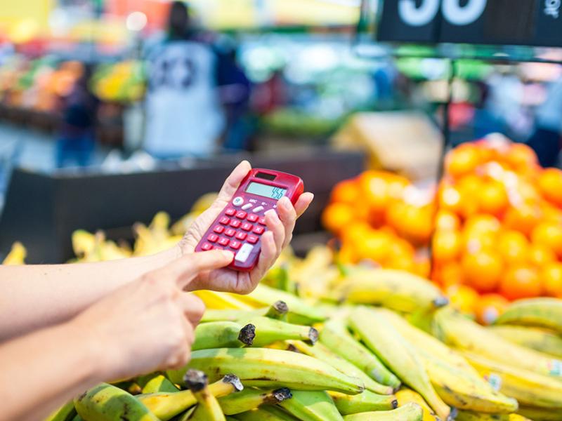 adding on a calculator in grocery store