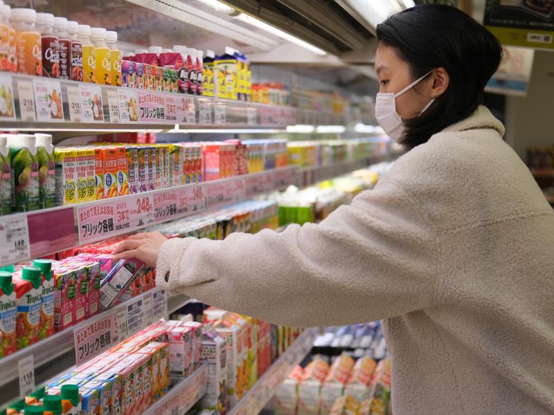 woman picking out beverage