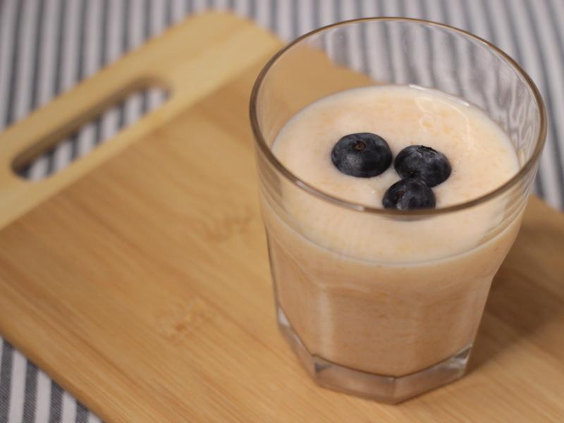 clear glass with orange smoothie drink made from cantaloupe