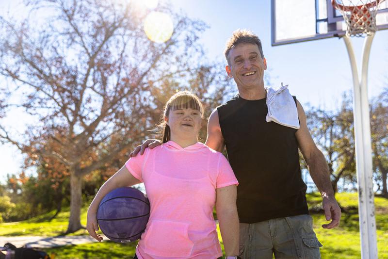 dad and daughter walking off basketball court